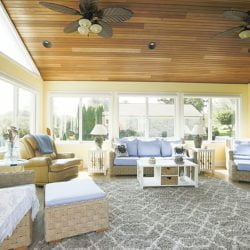 three season sunroom with wood ceilings and beachy furniture