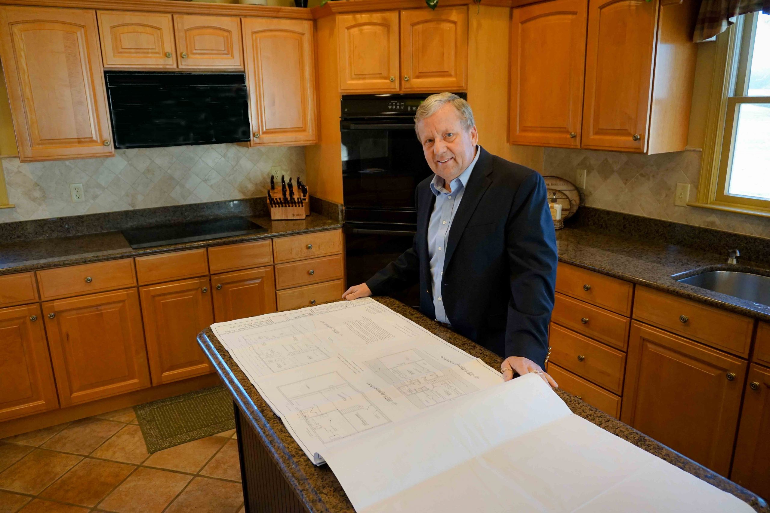 image of donald lynch jr in a kitchen with house layout plans